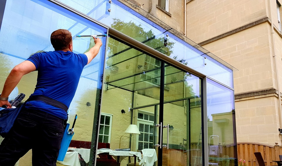 Professional window cleaner at work